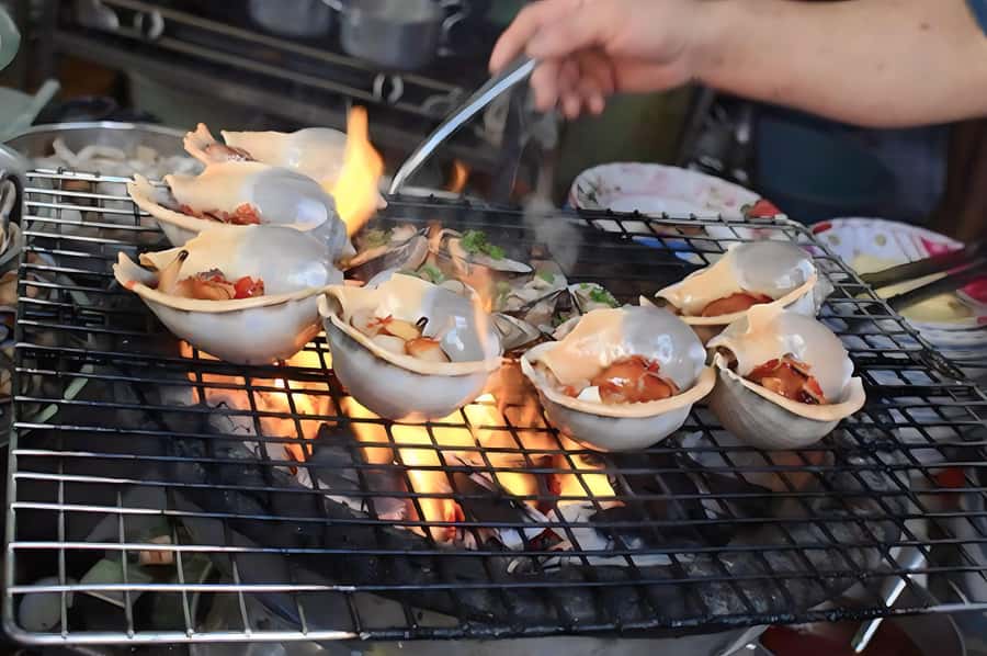 Saigon: Private Backstreets Walking Food Tour - Betel leaf beef and sausage-adjacent comfort food